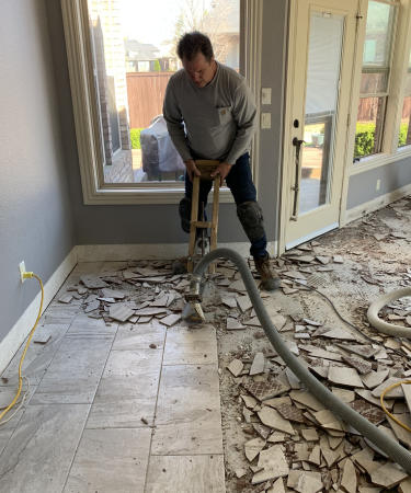 This is a picture of our hand held tile remover that has a vacuum hose attached to it to capture any dust that is produced. This job was in Siloam Springs AR.