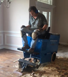 This is me sitting on our machine that removes old glue down wood floors and the glue that held it down. We are getting this ready for a new floating hardwood floor install in the Bentonville AR area.